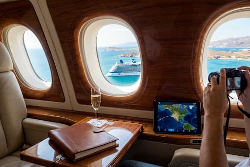 Private jet cabin looking out at a cruise ship