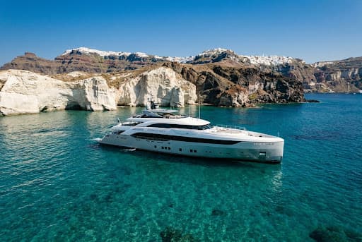 Luxury yacht anchored in clear blue water